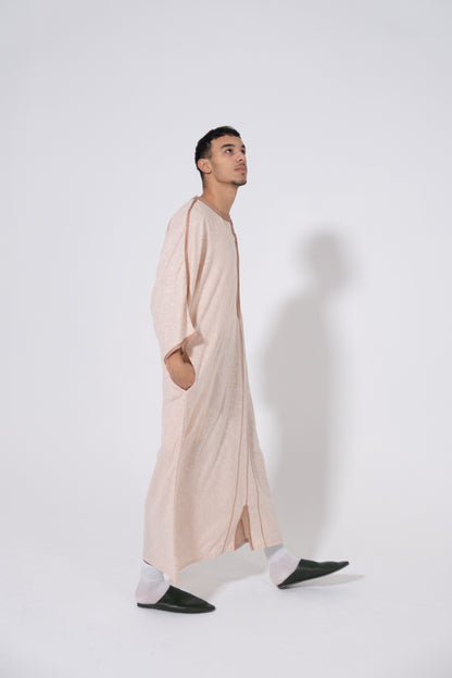 Experience luxury and tradition with our Moroccan Gandoura-thobe for men. This beige garment is expertly crafted with premium materials, perfect for Eid and Ramadan celebrations. Add a touch of elegance to your wardrobe.