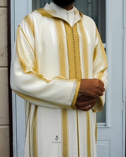 Person wearing a white and gold striped garment with 'Almuhaj' branding.