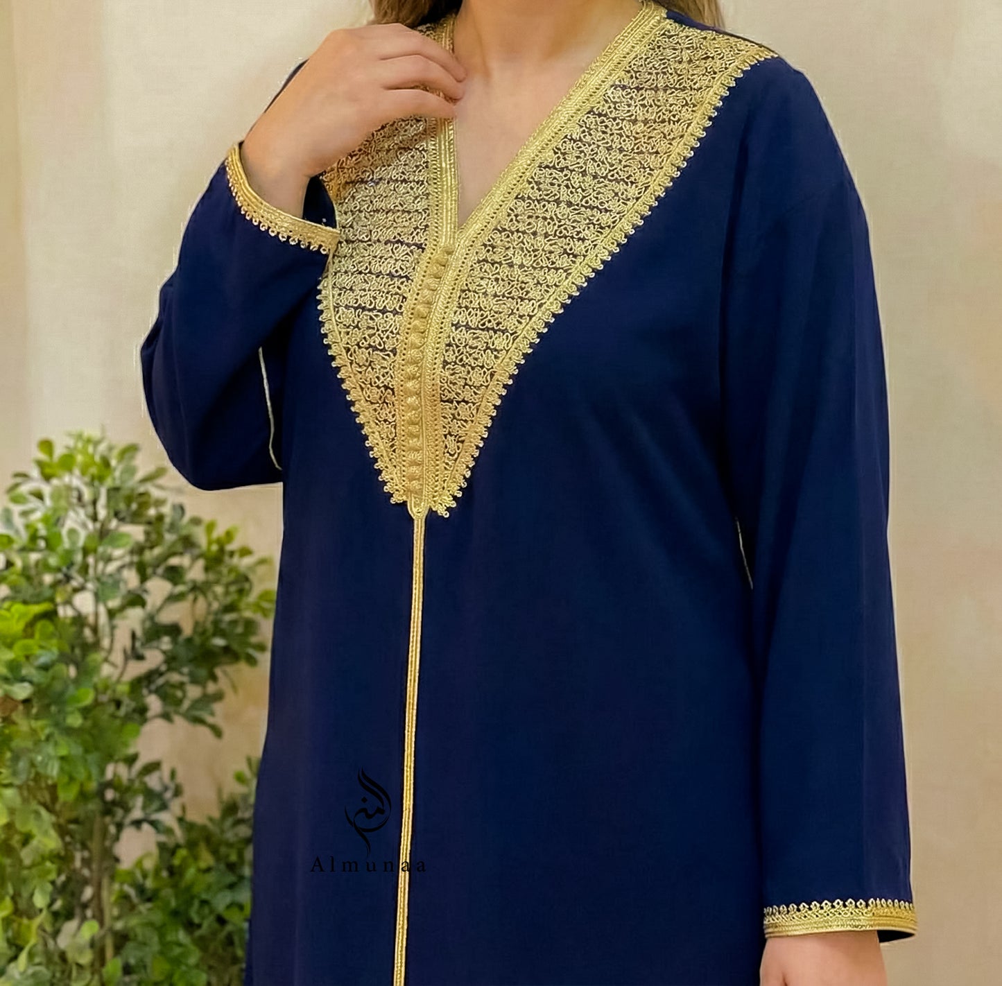Navy blue kurta with gold embroidery on a neutral background