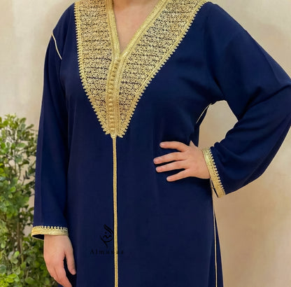 Navy blue dress with gold embroidery on a neutral background